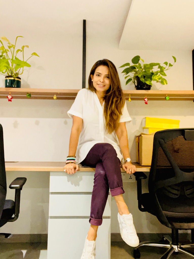 Mahuua sitting in her office workspace